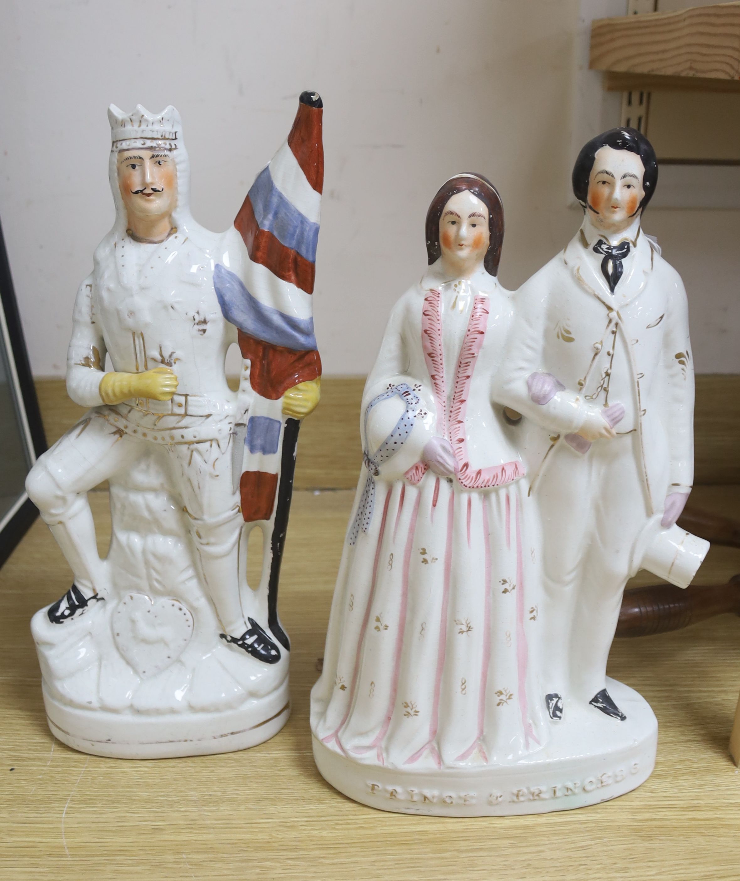 A large Staffordshire group of a prince and princess, and a military figure with a flag, tallest 41cm